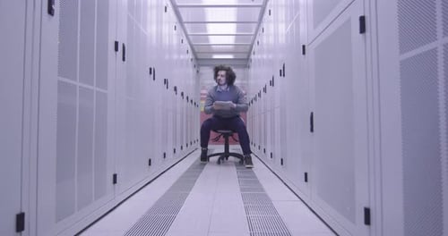 Man Using Tablet in a Server Room