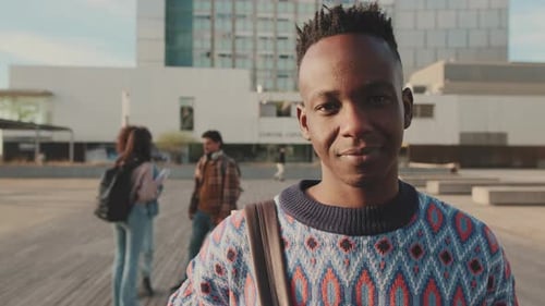 Close-up of a young man looking at the camera and smiling