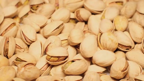 Pile of pistachios in shells, macro shot