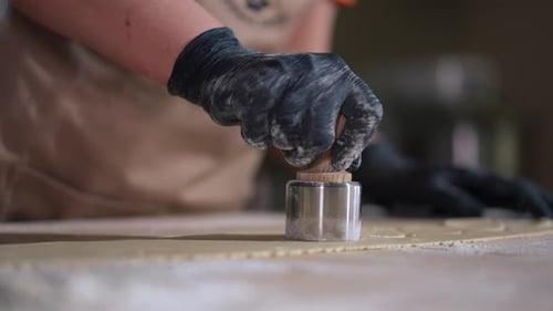 Closeup Cutting Dough Circles with Tool in Cafe Kitchen Indoors Closeup Unrecognizable Caucasian