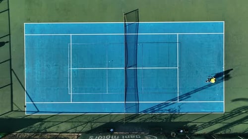 View From Above Aerial View of Two People Playing Tennis on a Blue Court aerIAL VIEW