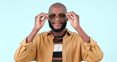 Sunglasses, smile and face of black man in a studio with stylish, cool and trendy fashion