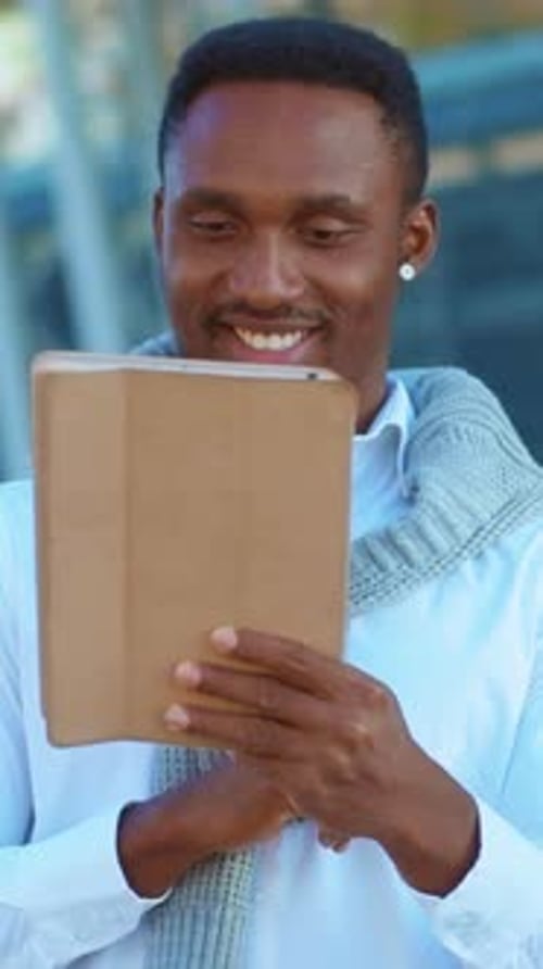 A Young Man Engaged in Various Forms of Technology Amidst a Bustling Urban Setting