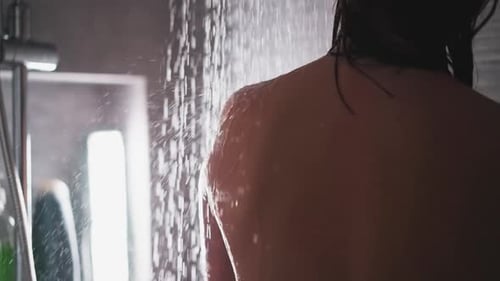 Woman Washing in Shower Under Running Water
