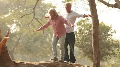 Senior Couple Enjoys Playful Balance Activity in Park