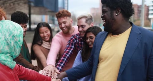 Friends Congregate in City, Stacking Hands