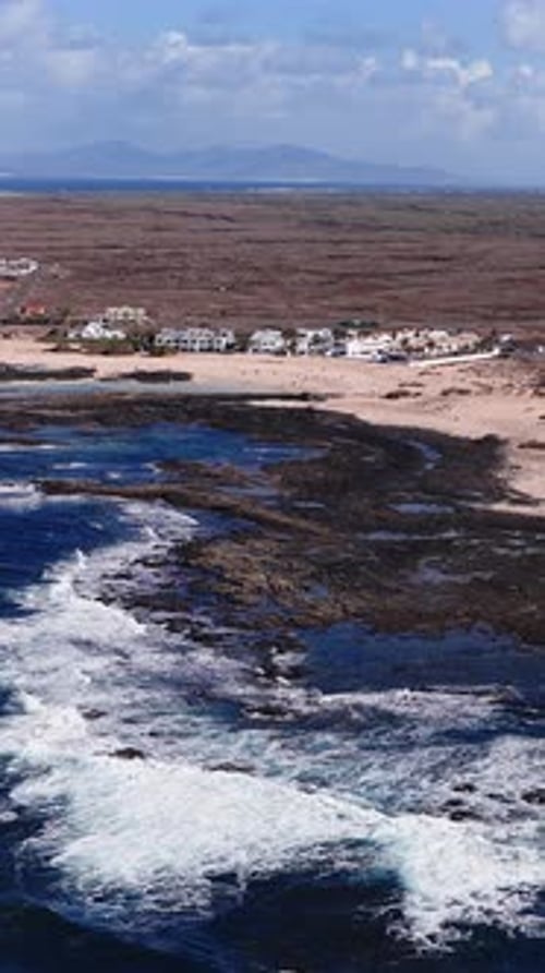 Aerial Volcanic Coast of Fuerteventura with Lanzarote on Horizon