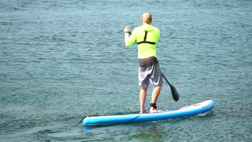 Man Sup Sea Strong Athletic Man Learns to Paddle Sup Standing on Board in Open Sea Ocean on Sunny