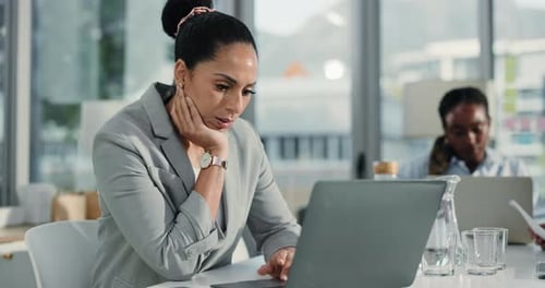 Businesswoman Feeling Stressed at Office Desk Using Laptop