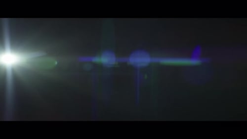 Lucent Precise Collection: A big blue lens flare blinking from the bottom right corner on a black ba