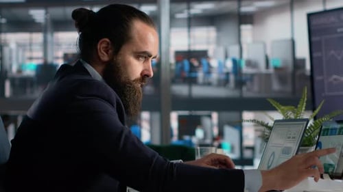 Man in Suit Working with Laptop in Office