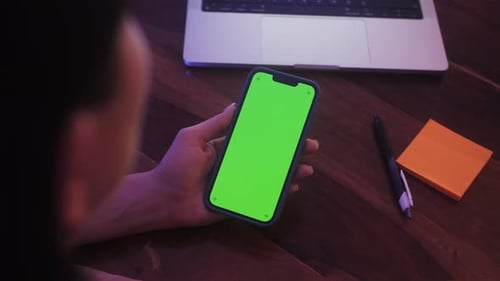 Woman Holding Chroma Key Green Screen Smartphone Watching Content Without Touching or Swiping Person