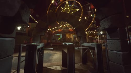 Empty Amusement Park Entrance at Night with Illuminated Attractions and Rides