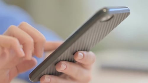 Close up of Female Hand Text Messaging on Smartphone