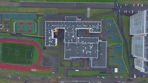 Aerial top view of the school with stadium and outdoors sports infrastructure.