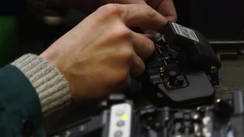 Worker Welds Optical Line Internet Wire with Welding Machine Service Man Soldering Optical Fiber