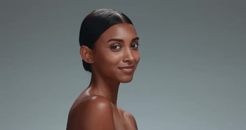 Happy woman, face and relax in skincare, natural beauty or cosmetics against a grey studio