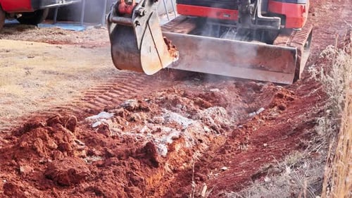 Heavy Machinery Removes Soil Prepares Land for Construction in an Outdoor Area