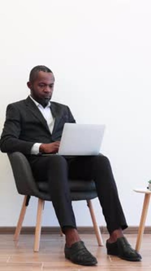 Thinking Businessman with Laptop