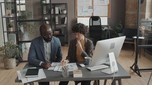 Coworkers Discussing Project Data and Tasks