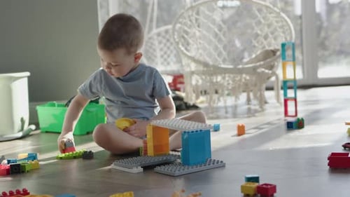 Caucasian Child Boy Kid Building House with Colorful Plastic Bricks Parts
