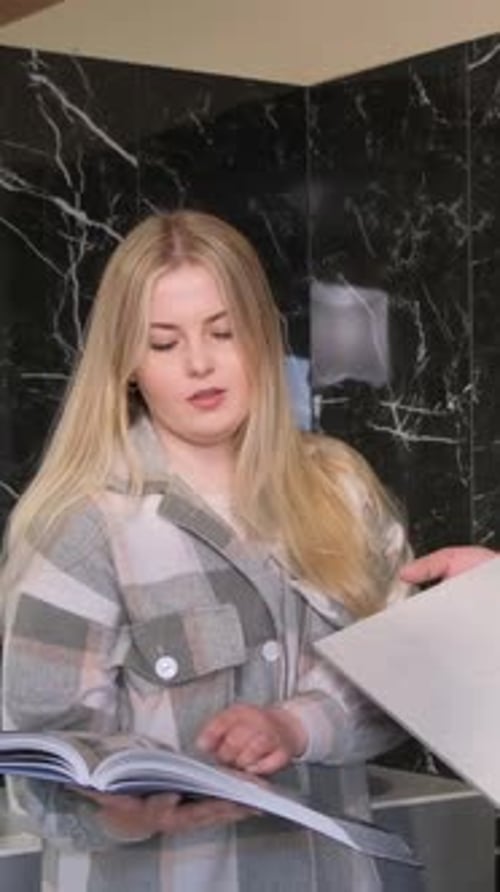 Woman with Blonde Hair Browsing Catalog