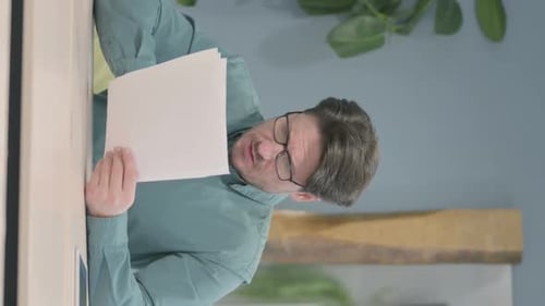 Adult Reading Documents in Office