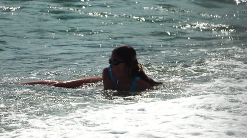 Girl Sea Wave Teenagers Girl in Blue Swimsuit and Water Goggles Playing with Waves on the Beach