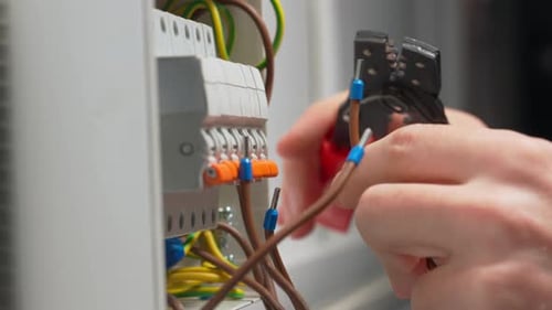 Electrician Working on Wires in a Panel Close-up