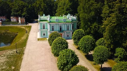 Beautiful park and garden with Baroque estate. Tourists walk in historical park