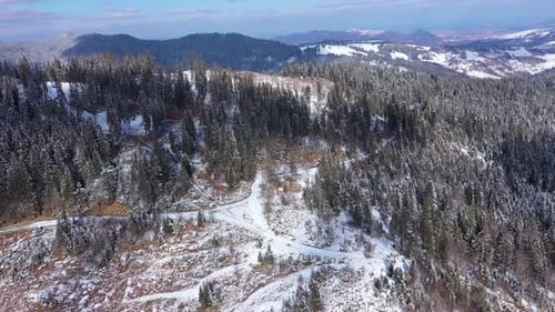 Aerial view of snow covered mountain forest at winter