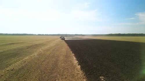 Tractors plowing the field in Ukraine