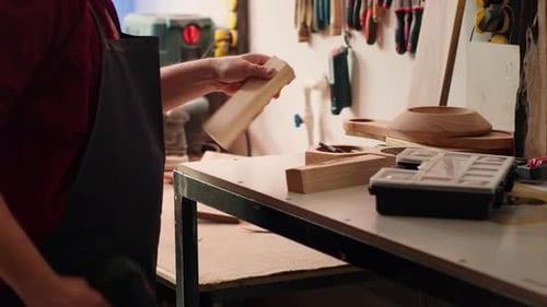 Craftsman Working with Wood Drill in Workshop