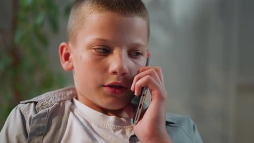Close-up of Boy Talking on Phone Indoors