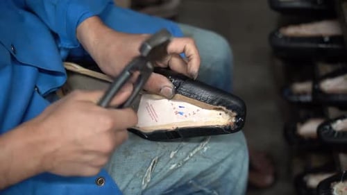 a craftsman handmade a shoe, close up shot, insert shot