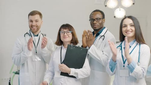 Group of doctors applause together at medical clinic