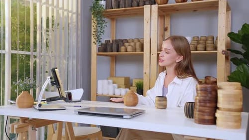 Woman Presenting Wooden Items Via Tablet