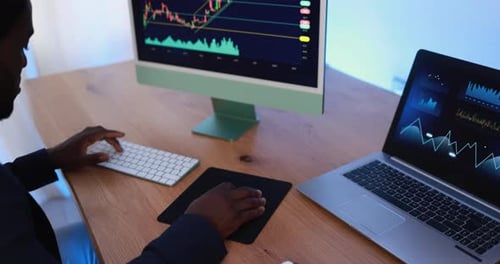 African fintech trader analyzing stock market data inside modern company office
