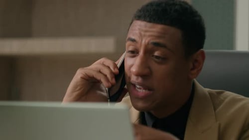 Man Talking on Phone in Office Environment