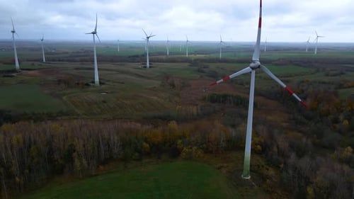 Aerial shot of a group rotating wind turbines in a wind farm for renewable electric power production