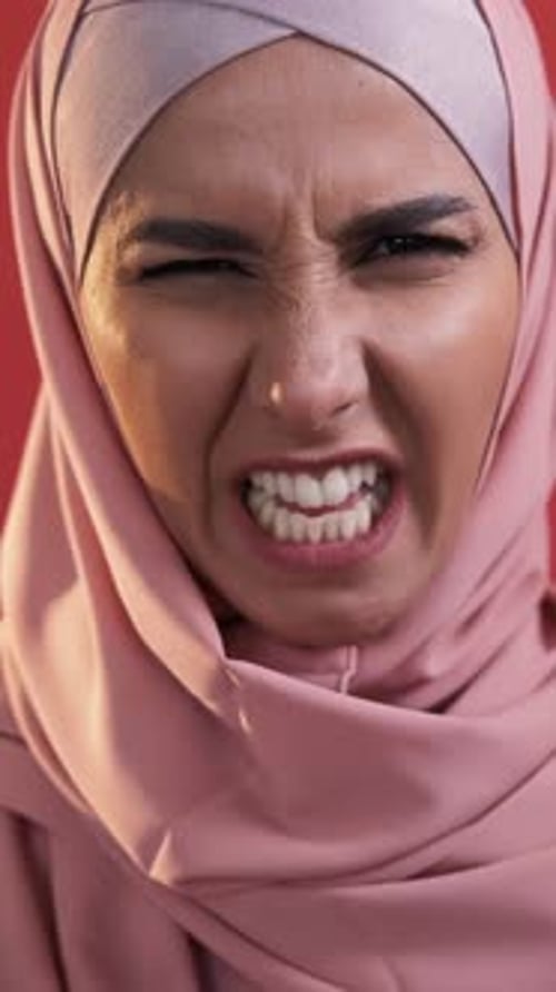 Woman Grimacing and Baring Teeth in Close Up