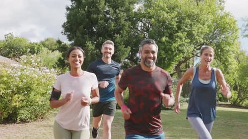 Healthy Group of Multiethnic Middle Aged Men and Women Jogging at Park