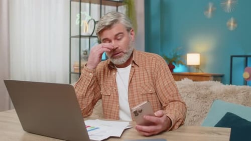 Tired Man Working from Home with Laptop