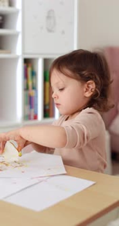 Young Child Happily Painting with Brush Indoors