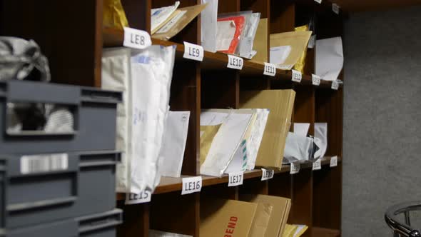 A post office mail room and sorting office with letters and shelving ...
