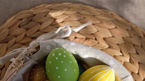 Easter Colorful Eggs in Busket on White Wooden Table