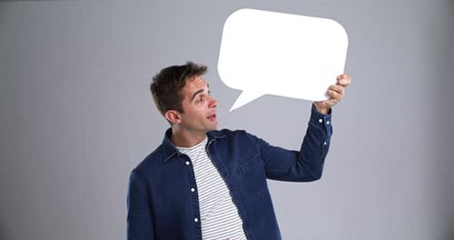 Smiling Man Holding Blank Speech Bubble