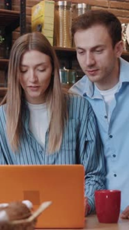 Young Couple Using Laptop Computer Together at Home