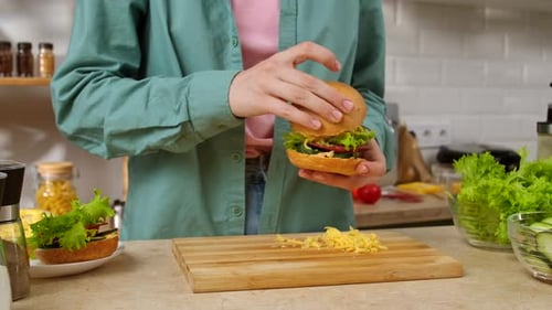 Woman Making Delicious Sandwich with Cheese in Kitchen
