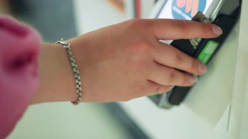 Hand swiping credit card at payment terminal